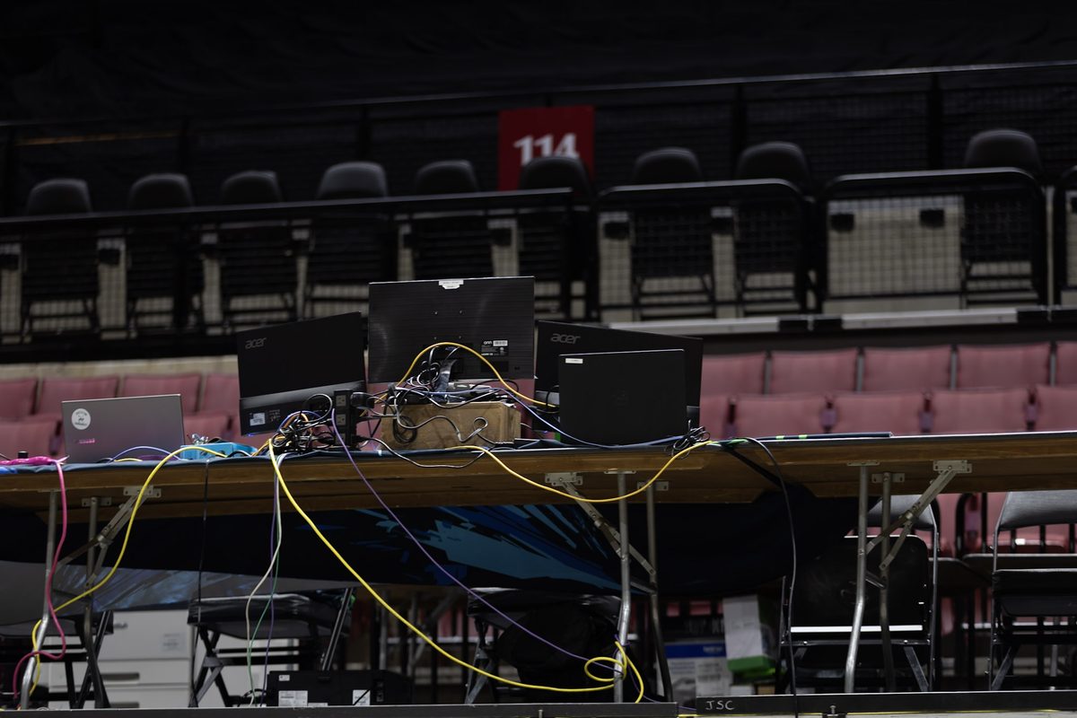 Scoring table with monitors and cabling being set up